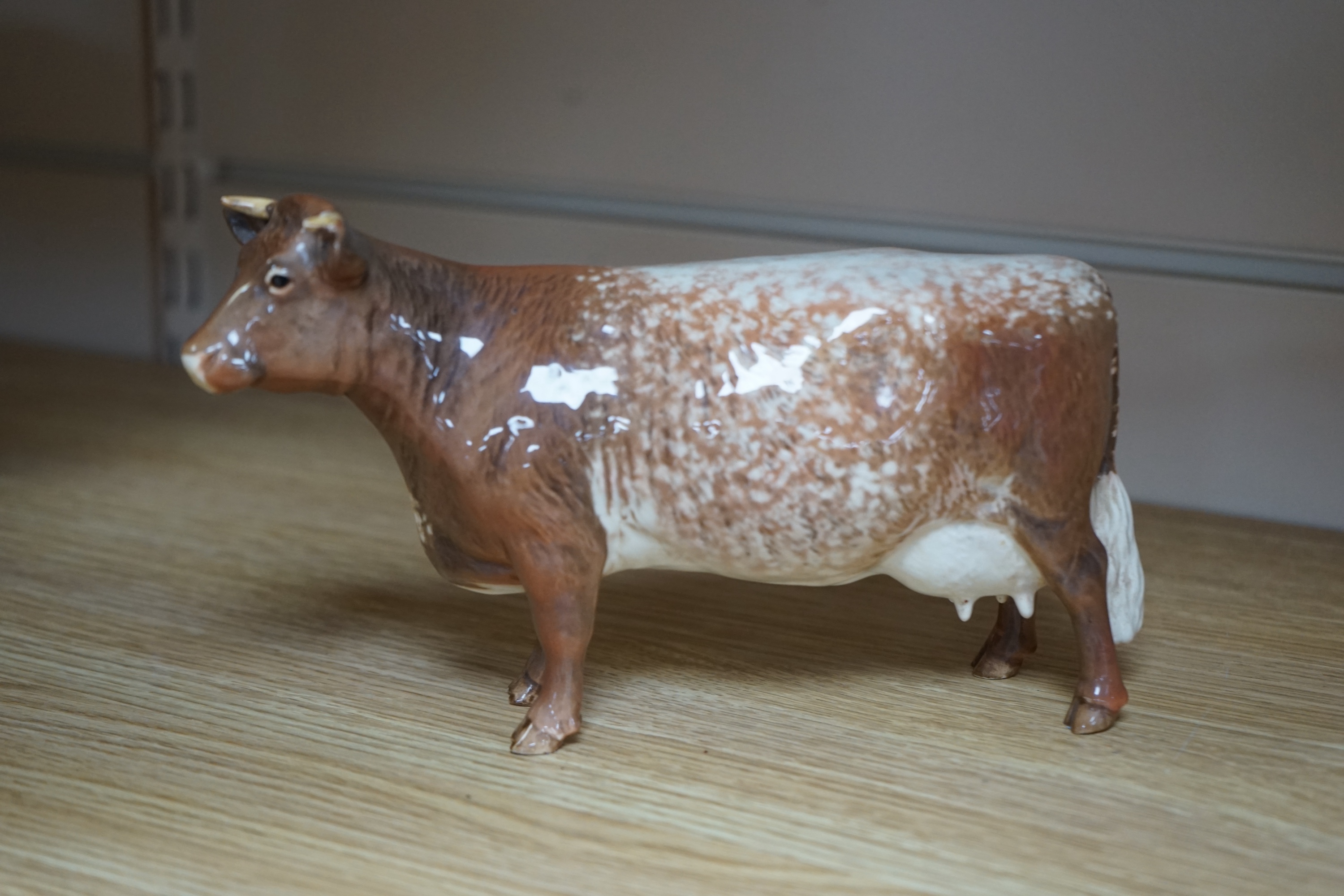 A Beswick model of a Shorthorn cow, ch. ''Eaton Wild Eyes 91st'', together with a Beswick Coddington Hilt Bar bull, 20cm. Condition - good